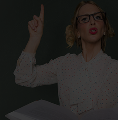 Female instructor holding a book and pointing upward, symbolizing compliance training through digital automation solutions.